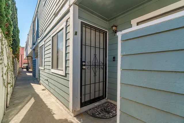 a view of a house with a door and wooden walls