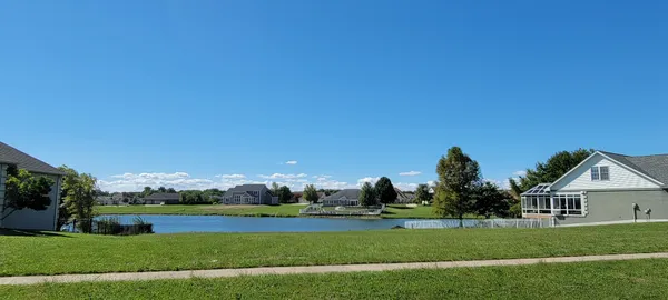 a view of house with a big yard
