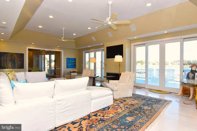 a spacious bedroom with a large bed and a flat tv screen