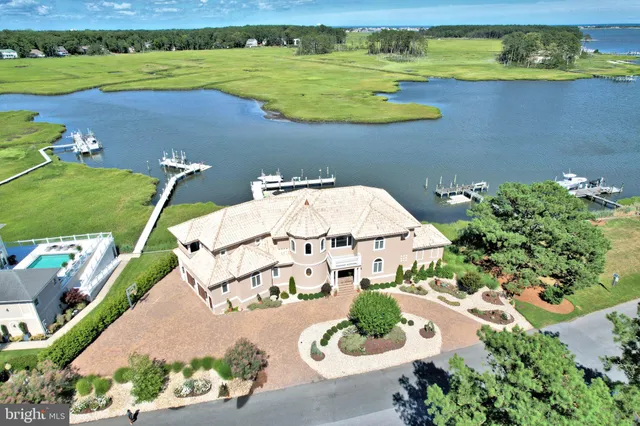an aerial view of a house with a ocean view