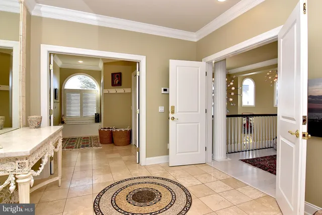a view of a hallway with wooden floor and windows