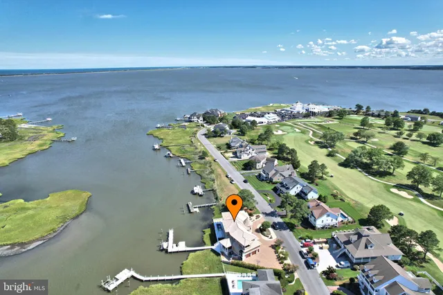 an aerial view of a house with swimming pool and a yard