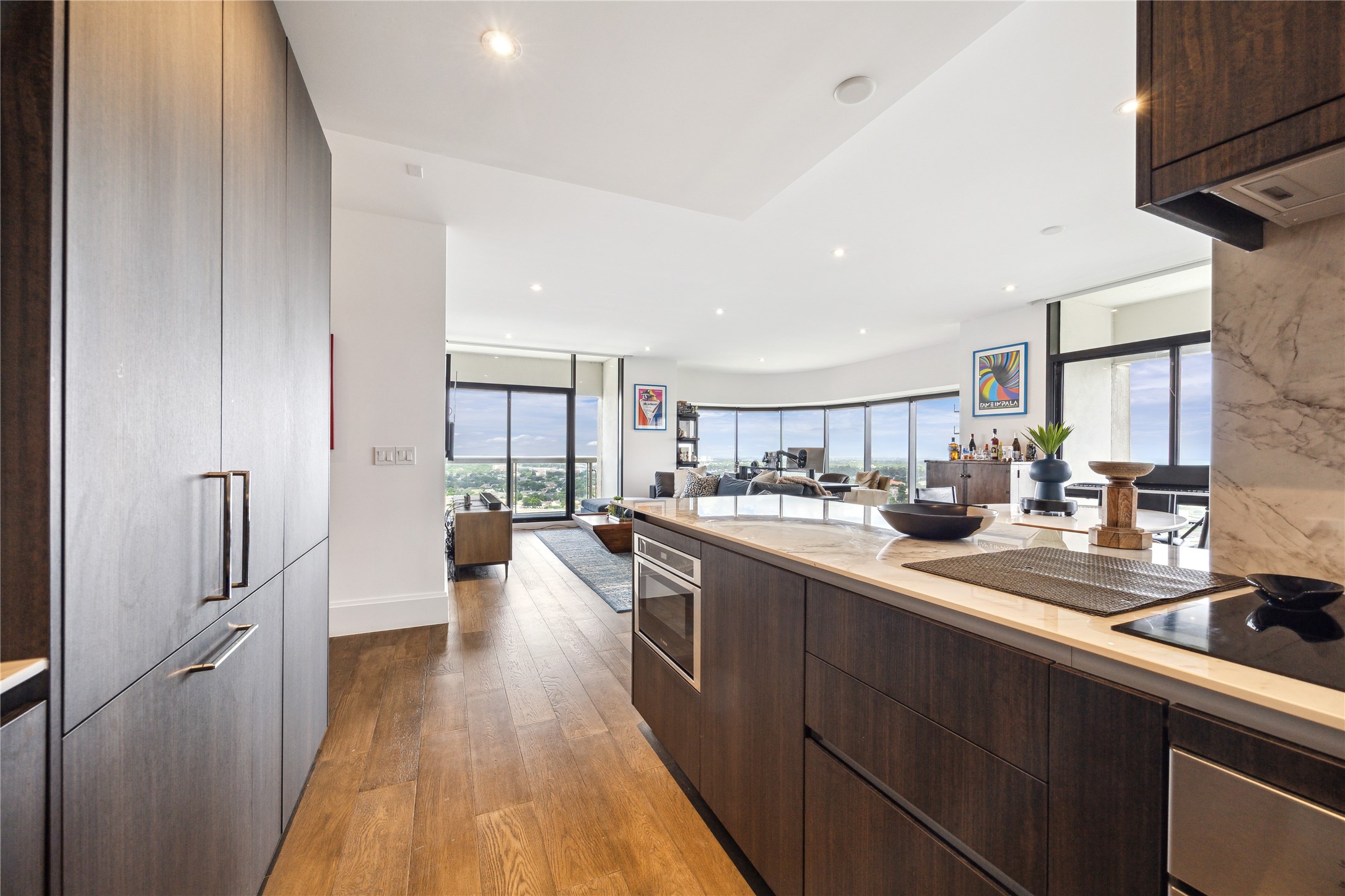 1701 Hermann Drive, Unit 23B Houston, TX 77004 - Photo 8 of 24 a large kitchen with a lot of counter space and wooden floor