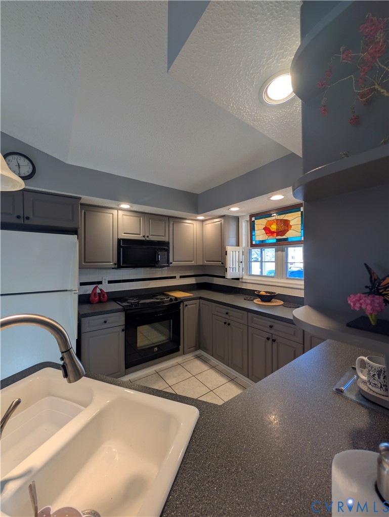 2701 Executive Drive Chester, VA 23831 - Photo 12 of 27 Kitchen featuring gray cabinets, black appliances,