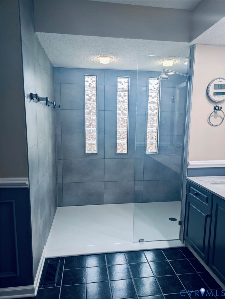 2701 Executive Drive Chester, VA 23831 - Photo 20 of 27 Bathroom featuring walk in shower, a textured ceil