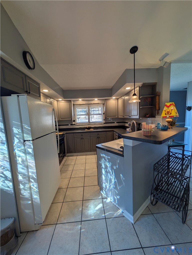 2701 Executive Drive Chester, VA 23831 - Photo 10 of 27 Kitchen with gray cabinets, pendant lighting, dark