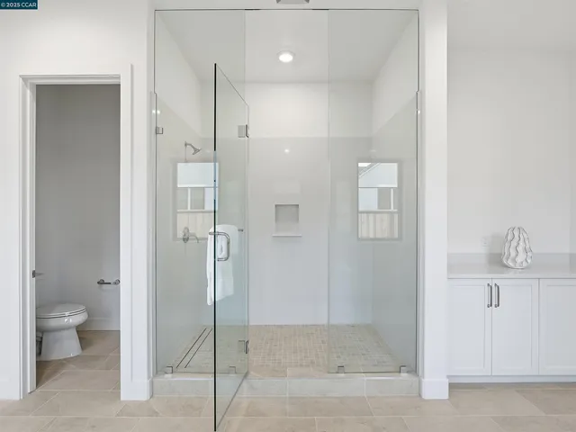 a kitchen with white cabinets and a sink