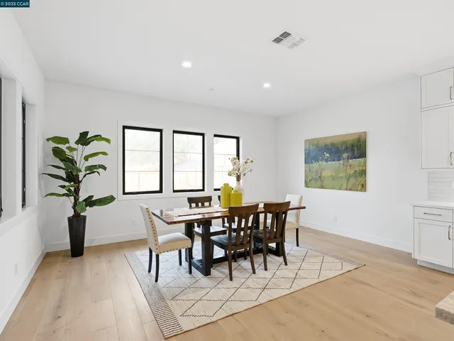 a living room with furniture and view of kitchen