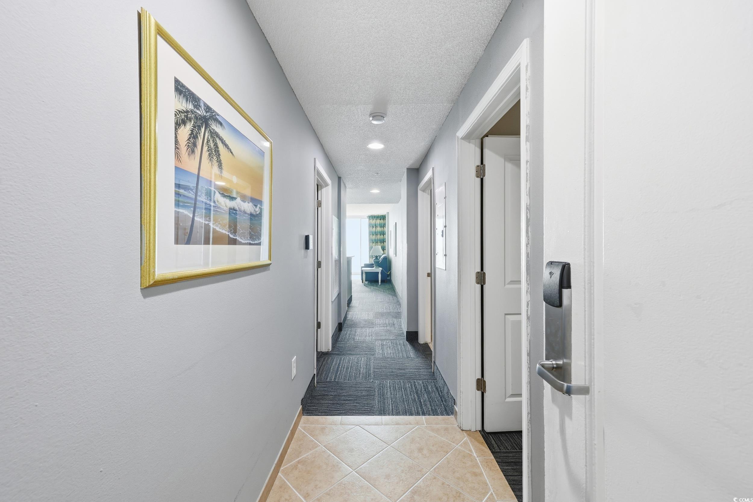300 North Ocean Boulevard, Unit 1608 North Myrtle Beach, SC 29582 - Photo 6 of 30 Hallway featuring light tile patterned floors, a textured ceiling, and recessed lighting