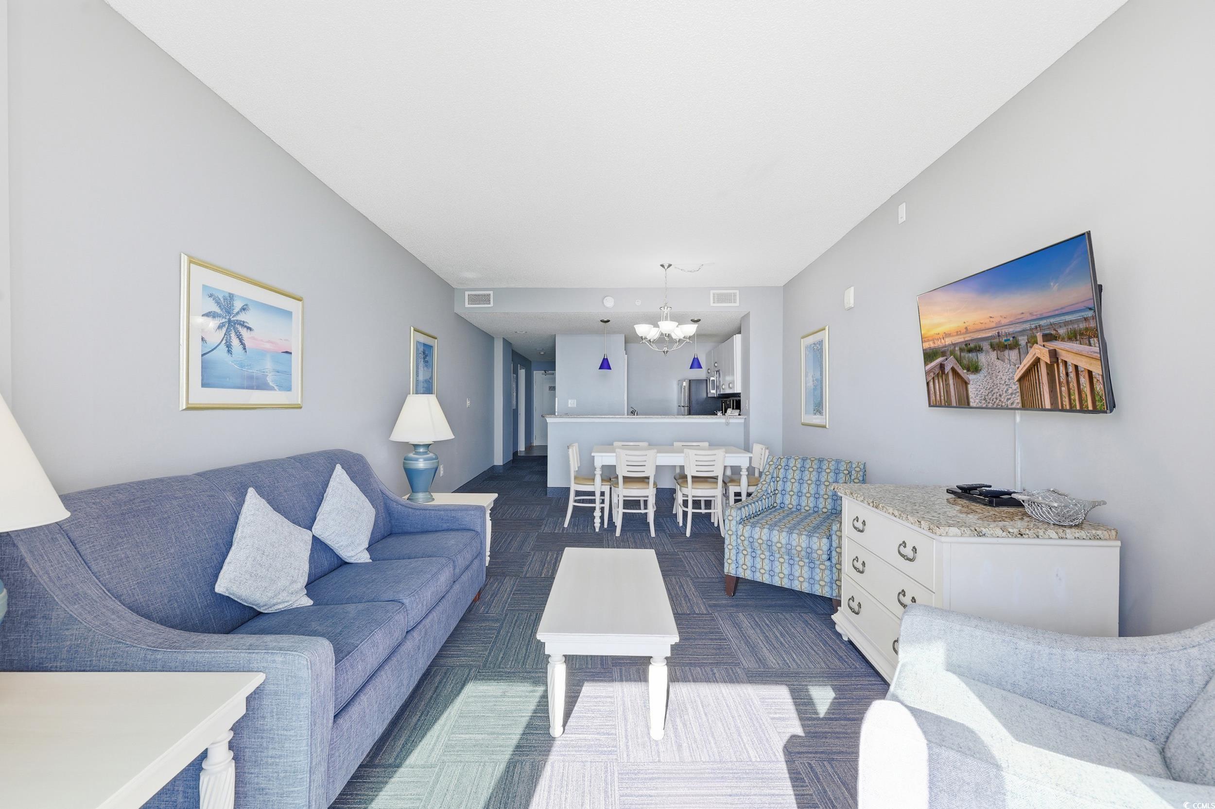300 North Ocean Boulevard, Unit 1608 North Myrtle Beach, SC 29582 - Photo 10 of 30 Living area featuring a chandelier and dark colored carpet