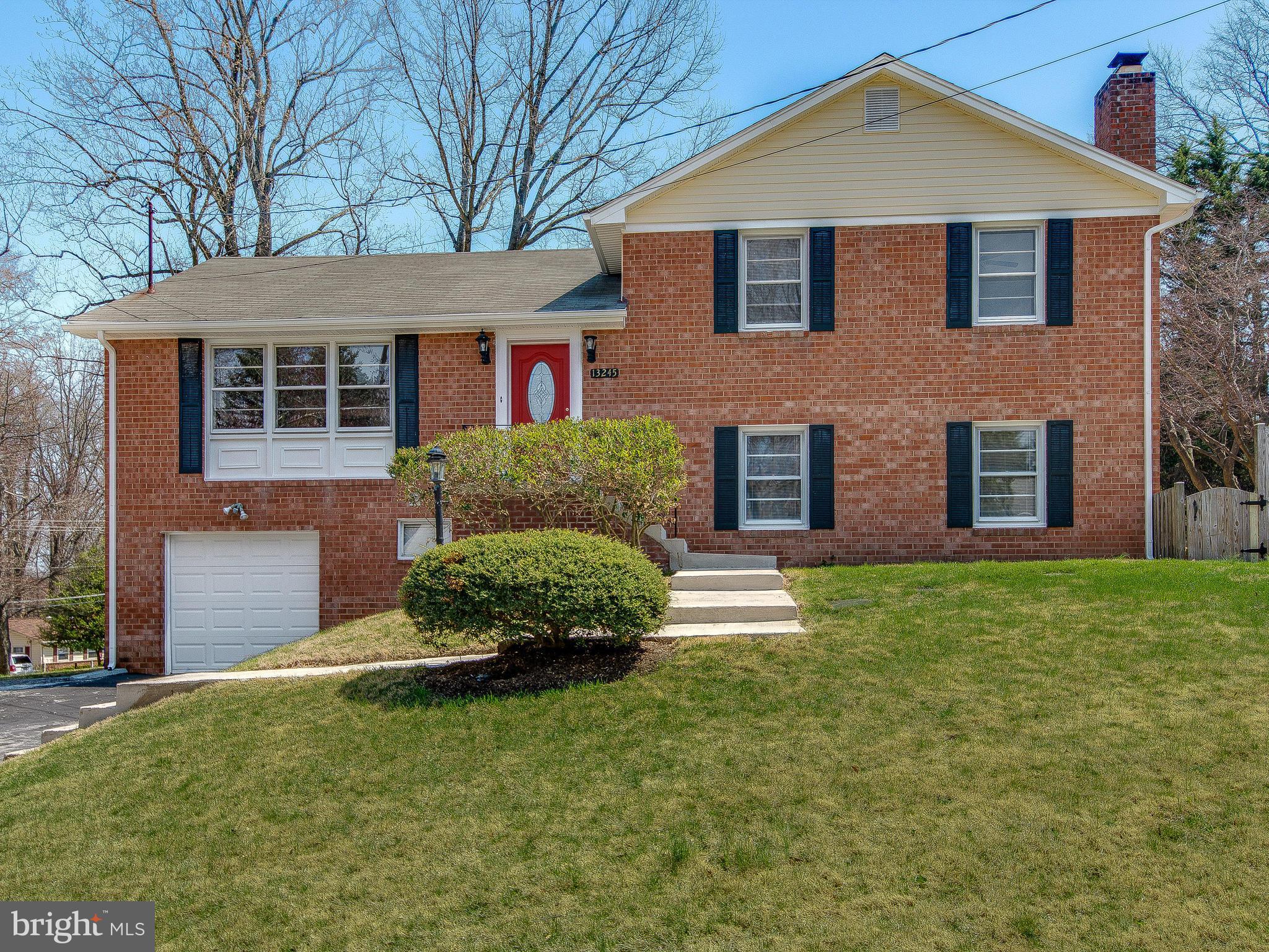 13245 Glenhill Road Silver Spring, MD 20904 - Photo 2 of 30 a front view of a house with a yard and garage