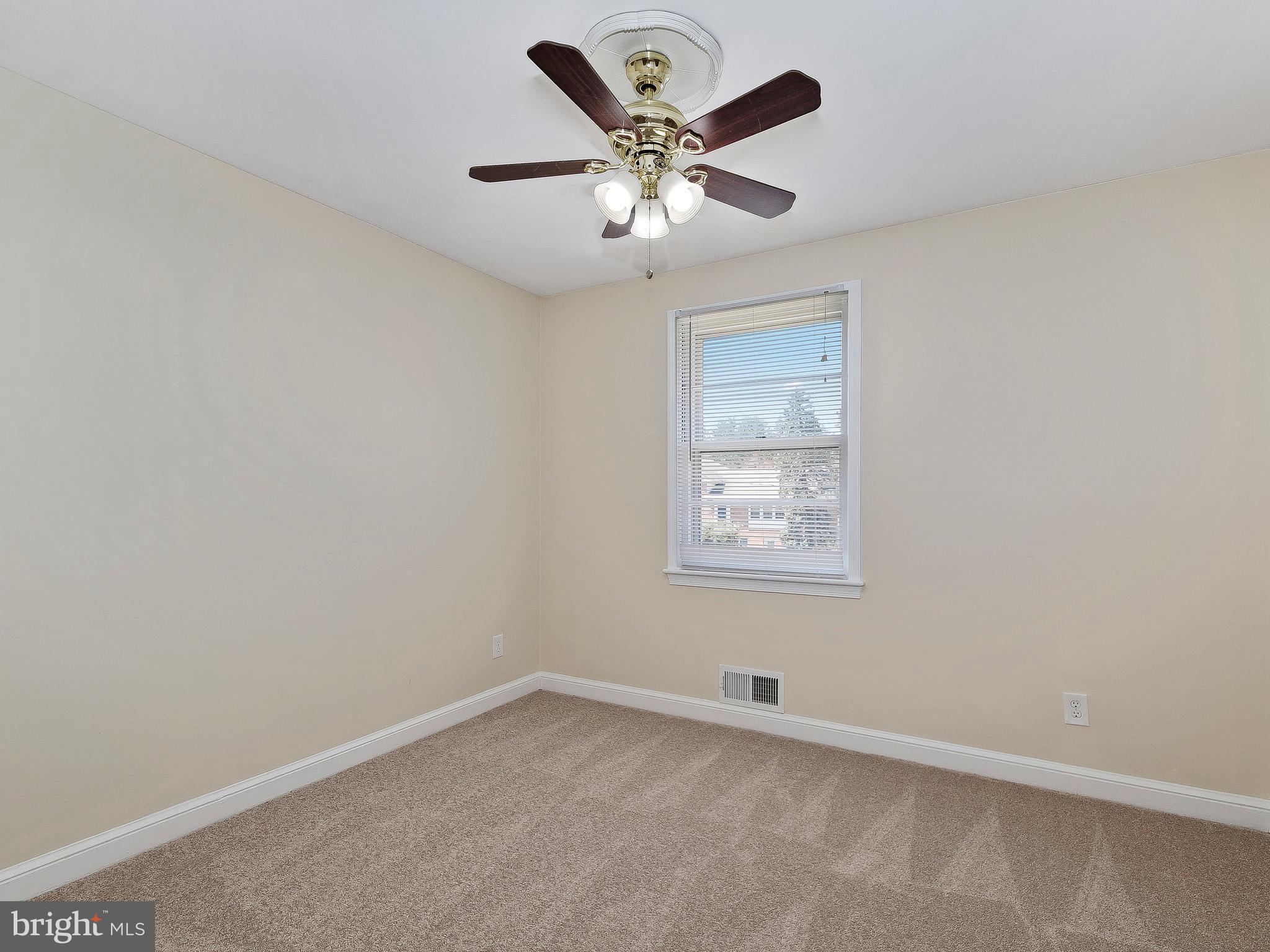 13245 Glenhill Road Silver Spring, MD 20904 - Photo 13 of 30 an empty room with a window and a ceiling fan