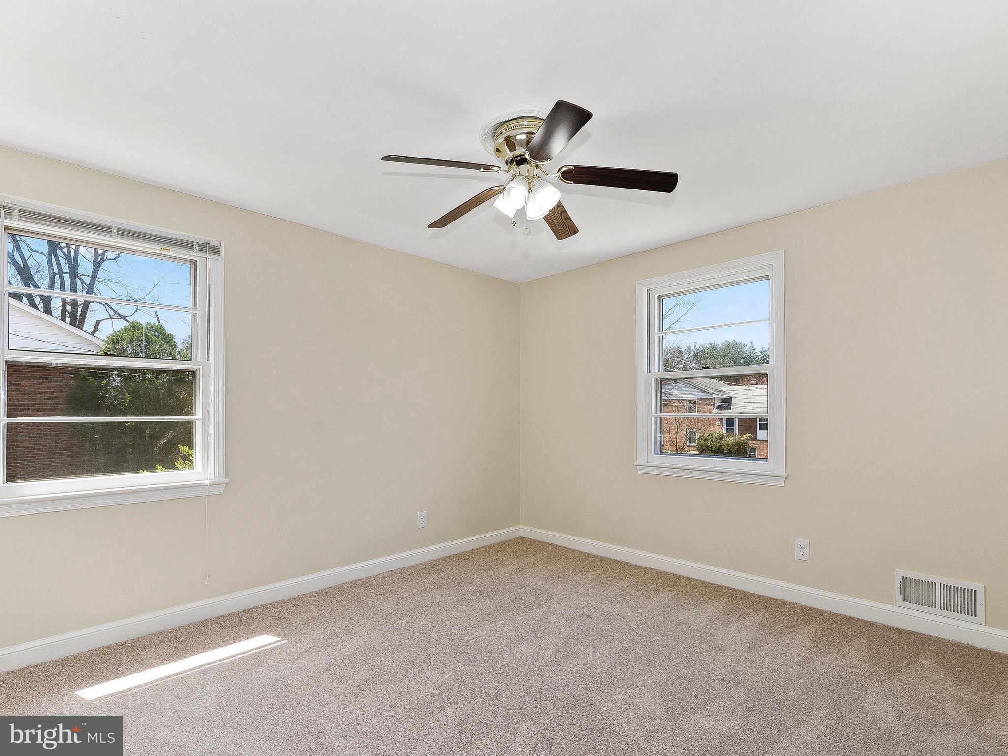 13245 Glenhill Road Silver Spring, MD 20904 - Photo 15 of 30 a view of empty room with window and ceiling fan