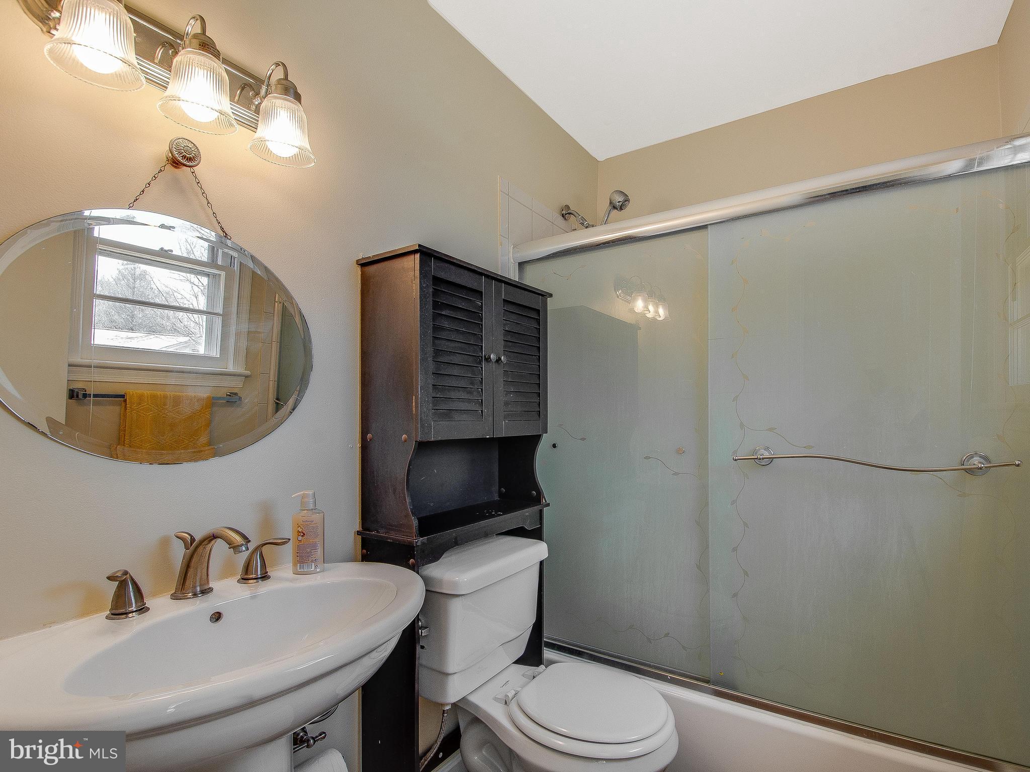 13245 Glenhill Road Silver Spring, MD 20904 - Photo 18 of 30 a bathroom with a sink toilet a mirror and shower
