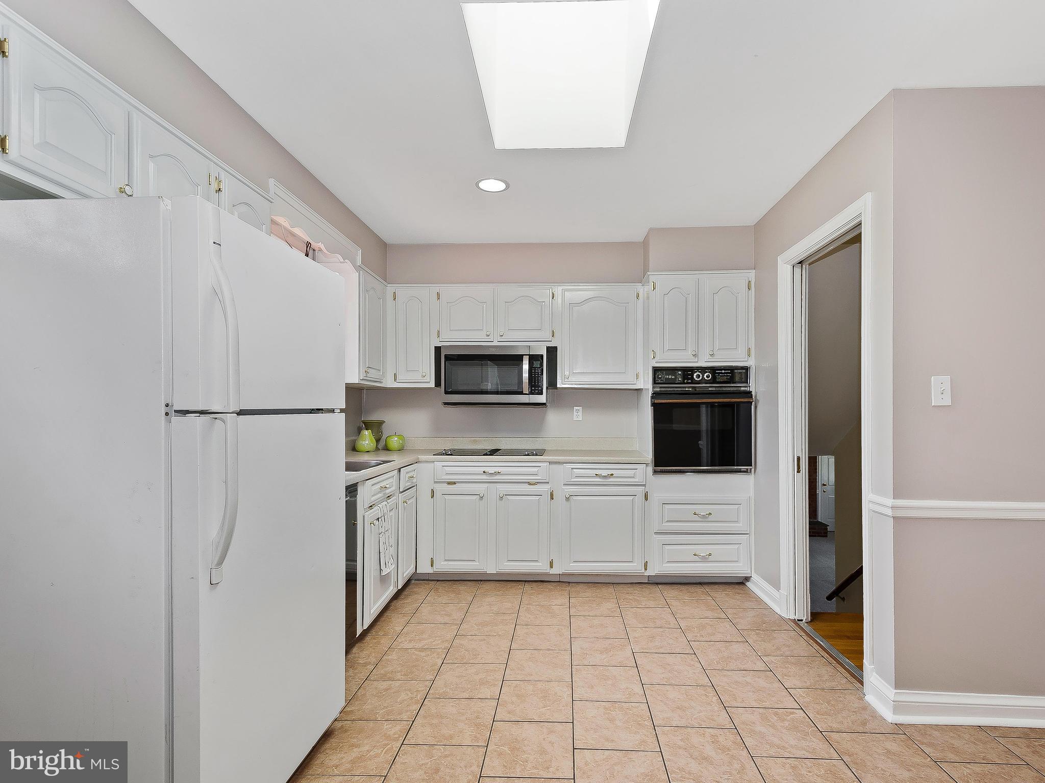 13245 Glenhill Road Silver Spring, MD 20904 - Photo 9 of 30 a kitchen with stainless steel appliances a refrigerator sink and microwave