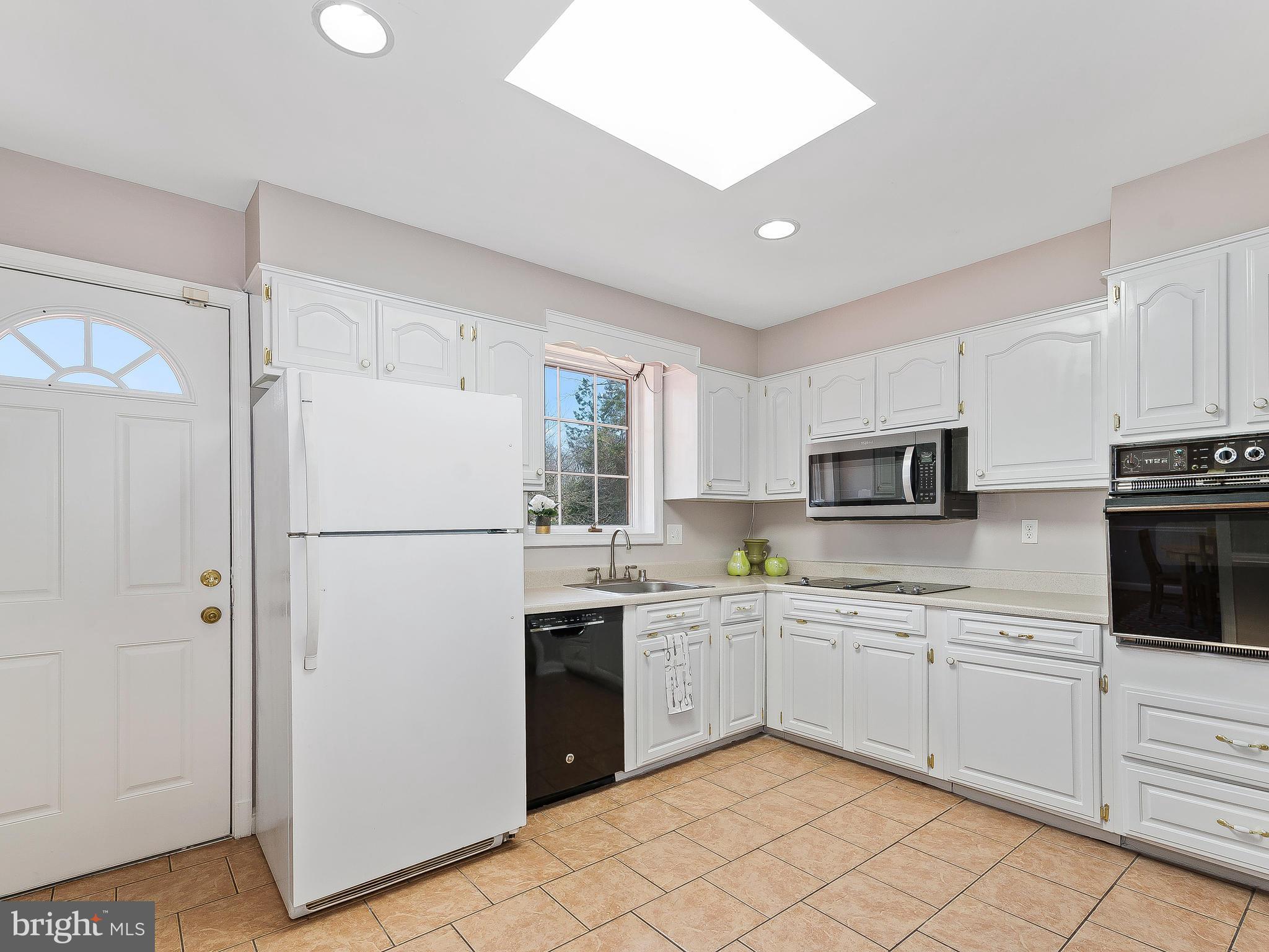 13245 Glenhill Road Silver Spring, MD 20904 - Photo 10 of 30 a kitchen with white cabinets sink and white appliances