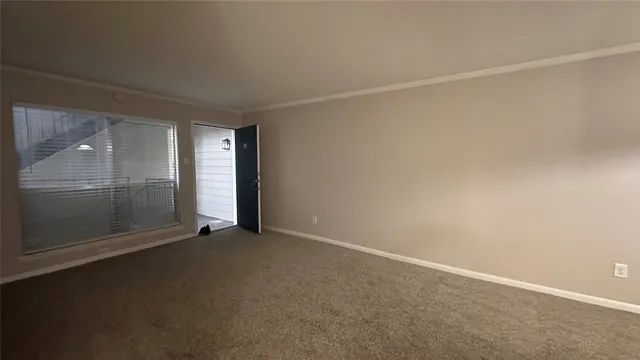 an empty room with sliding glass door