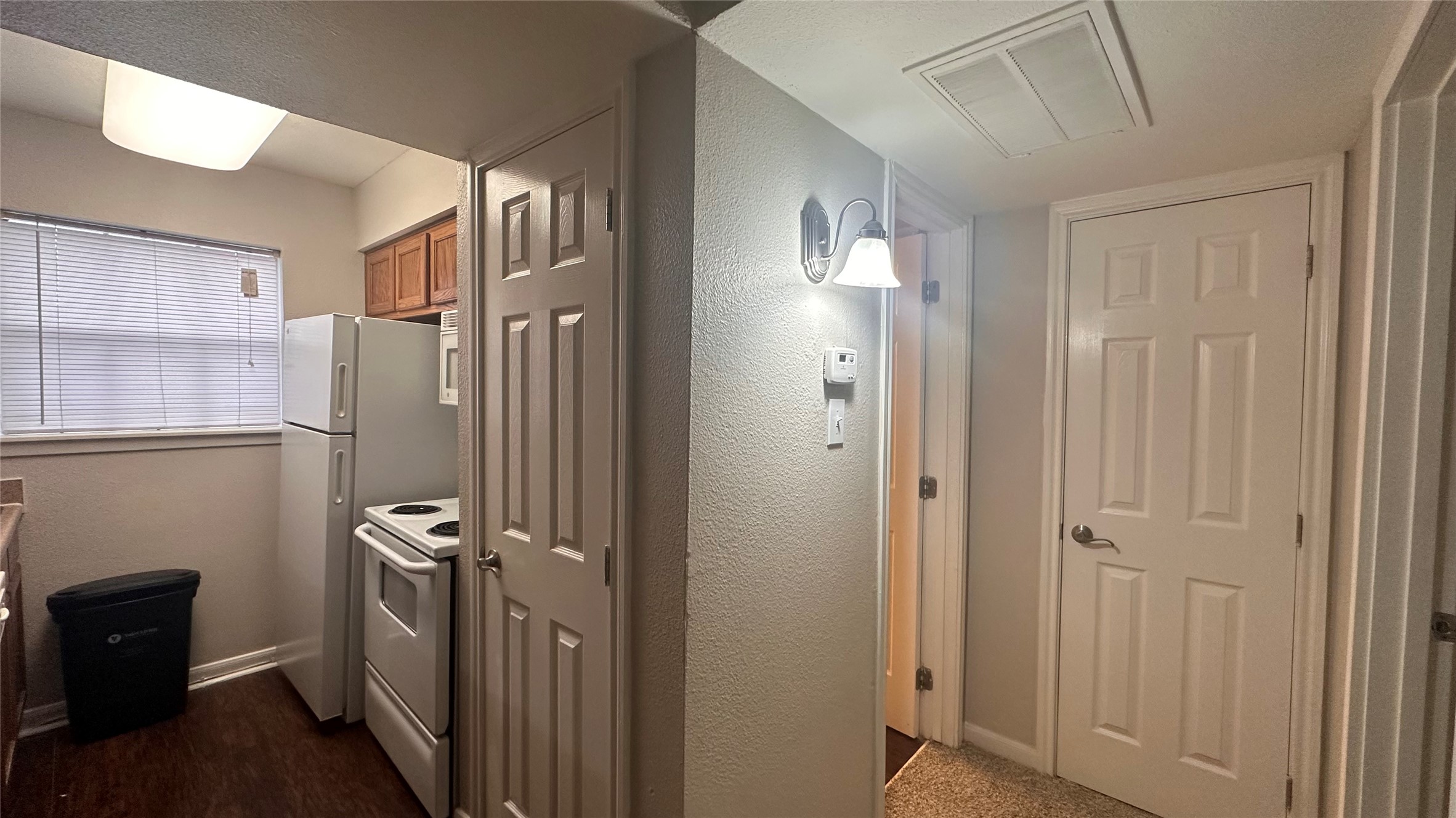 7315 Brompton Street, Unit 342B Houston, TX 77025 - Photo 3 of 17 a view of a hallway with closet and wooden floor