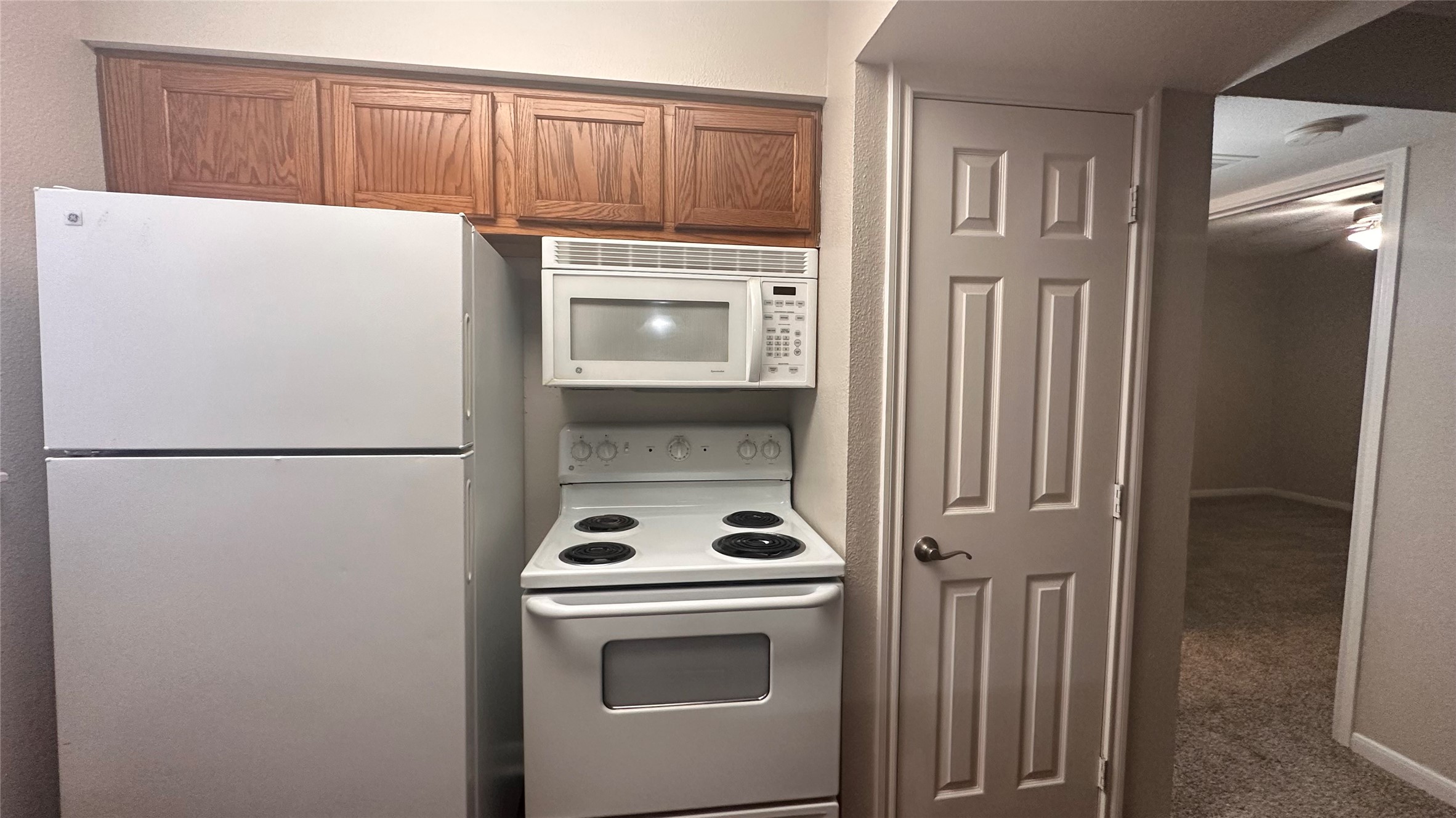 7315 Brompton Street, Unit 342B Houston, TX 77025 - Photo 9 of 17 a white refrigerator freezer and a stove sitting inside of a kitchen