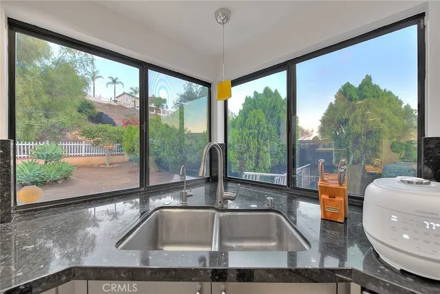 a dining room with a table chairs and kitchen view