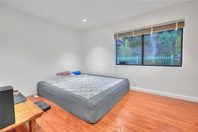 a room with a chair a piano and wooden floor