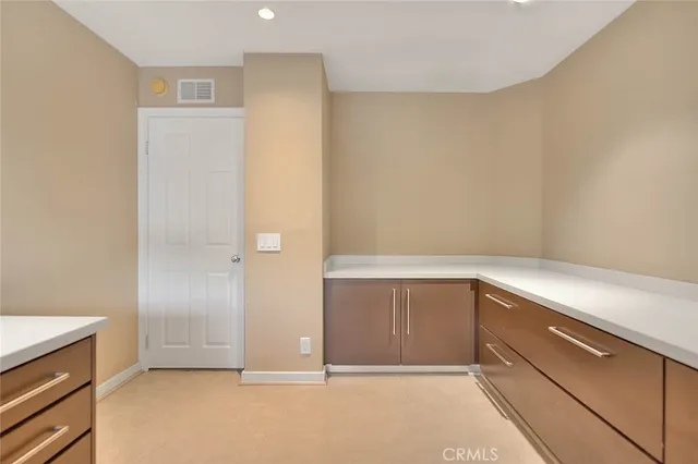 a spacious bedroom with a bed and glass door