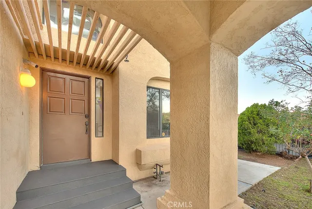 a view of a hallway with wooden floor and entryway