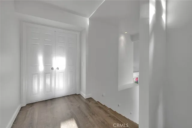 a view of a pathway of a building with large trees