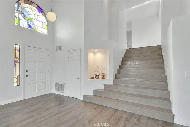 a view of entryway and hall with wooden floor