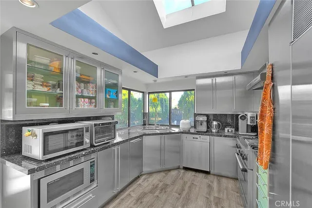 a stove top oven sitting inside of a kitchen