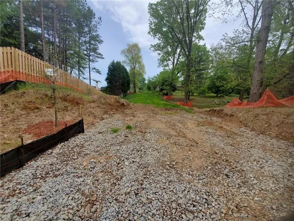 a view of a yard with large trees