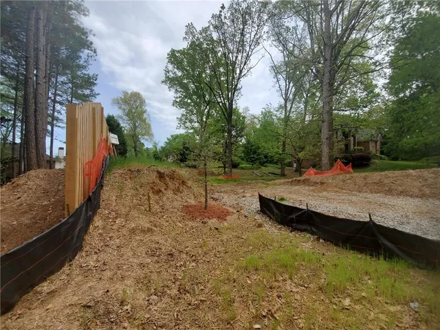 a view of a backyard with large trees