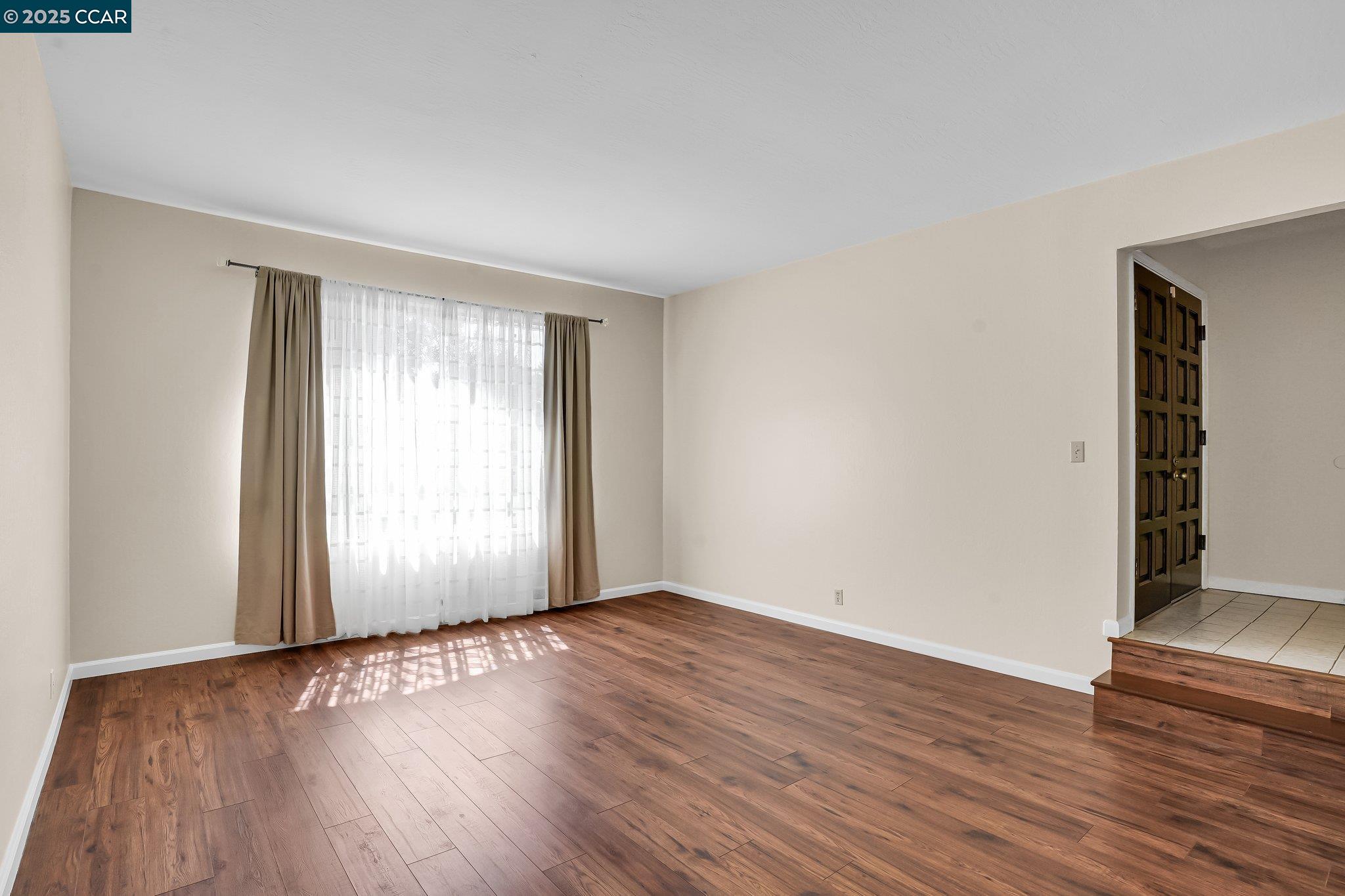 348 Barrett Circle Danville, CA 94526 - Photo 7 of 41 an empty room with wooden floor and windows