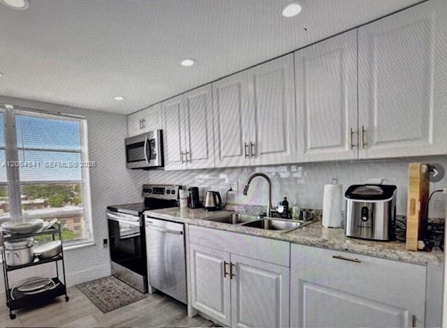 4174 Inverrary Drive, Unit 914 Lauderhill, FL 33319 - Photo 3 of 13 a kitchen with stainless steel appliances granite countertop a sink a stove a refrigerator and cabinets