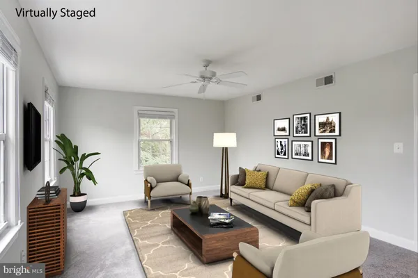 a living room with furniture and a potted plant