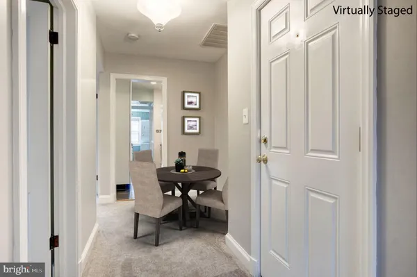 a view of a hallway with couch and a closet