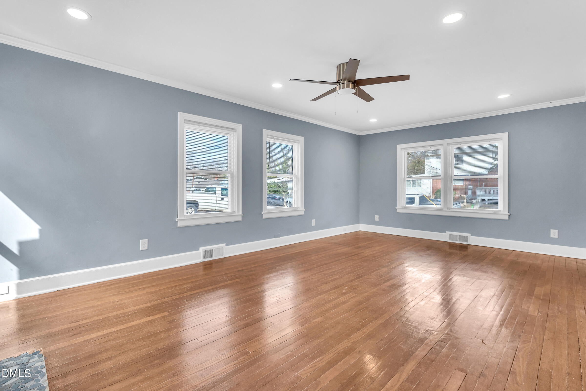 134 Nelson Street Durham, NC 27707 - Photo 10 of 25 a view of empty room with wooden floor and fan