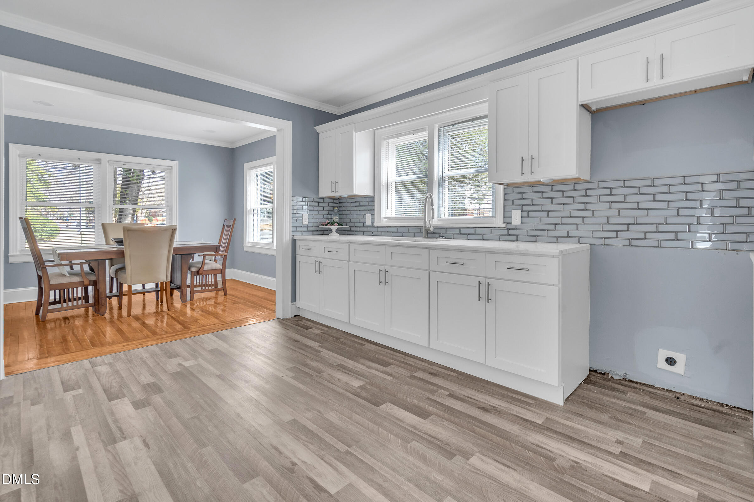 134 Nelson Street Durham, NC 27707 - Photo 14 of 25 a kitchen with stainless steel appliances granite countertop wooden floors and table