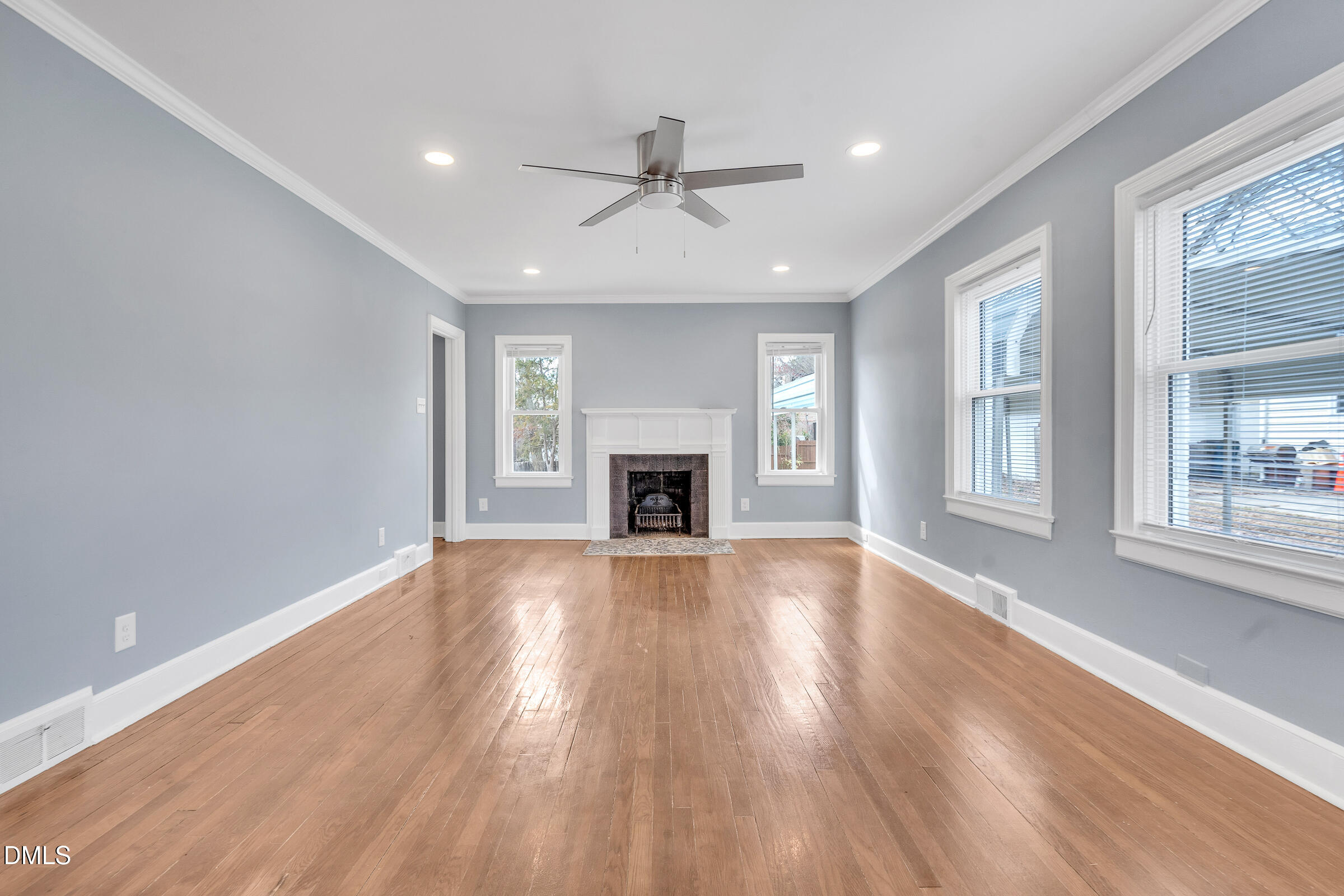 134 Nelson Street Durham, NC 27707 - Photo 8 of 25 a view of an empty room with wooden floor and a window
