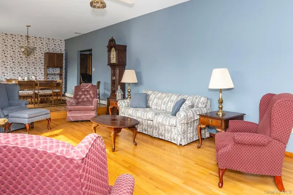 a living room with furniture and a lamp