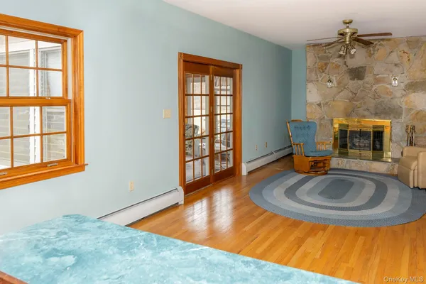 a view of a balcony with chairs and wooden fence