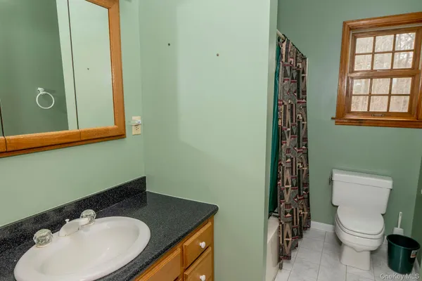 a bathroom with a bathtub and a window
