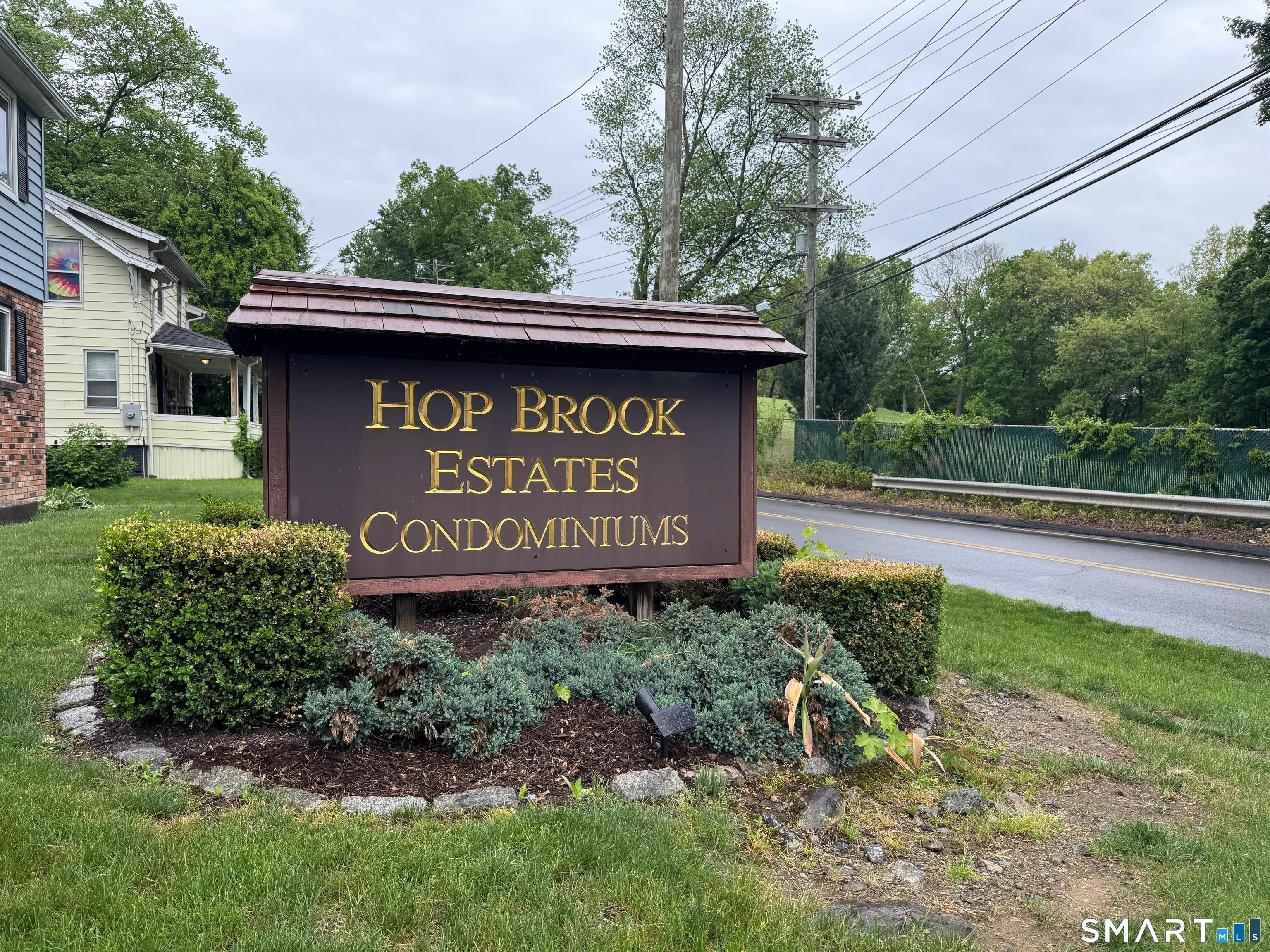 461 Spring Street, Unit 1A Naugatuck, CT 06770 - Photo 2 of 17 a sign on the side of the road