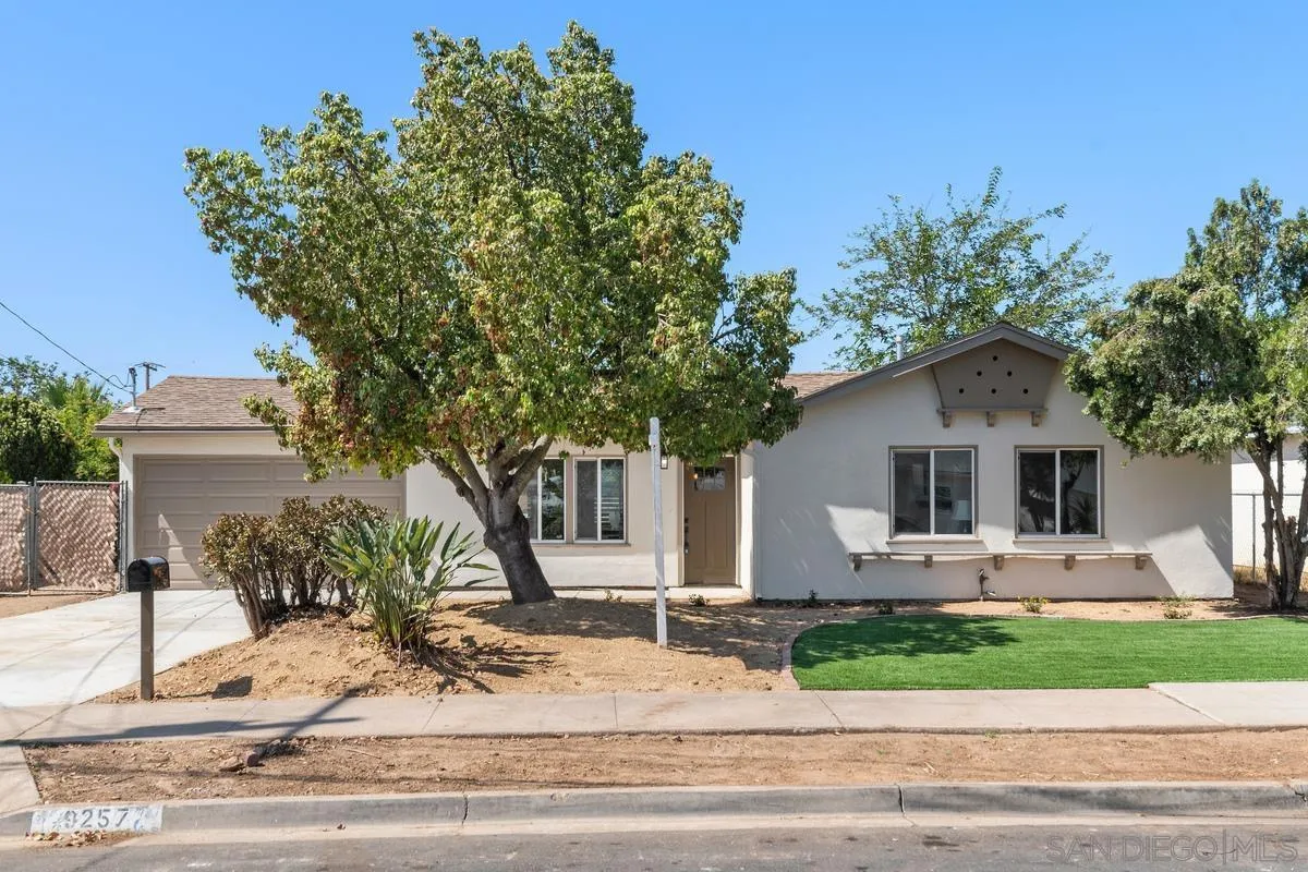 9257 Ruffin Road Santee, CA 92071 - Photo 1 of 28 a front view of a house with a yard and garage