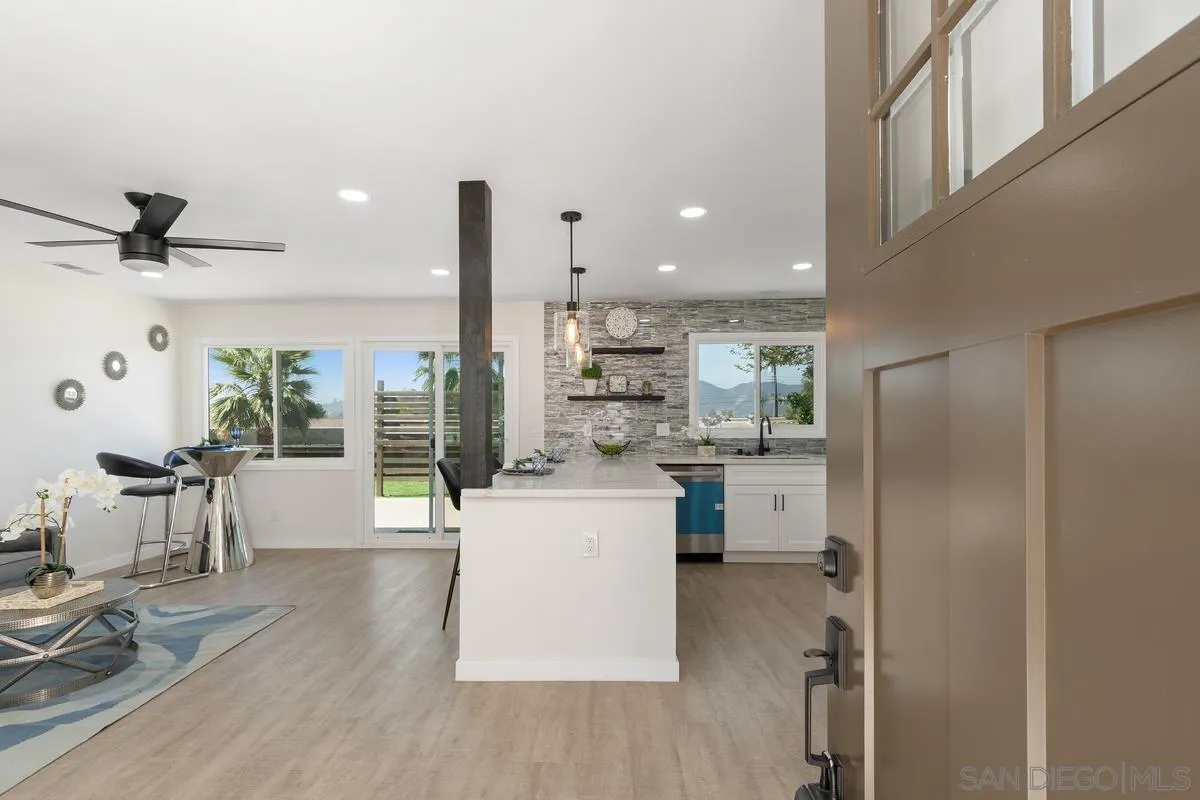 9257 Ruffin Road Santee, CA 92071 - Photo 2 of 28 a kitchen with stainless steel appliances kitchen island hardwood floor and a sink
