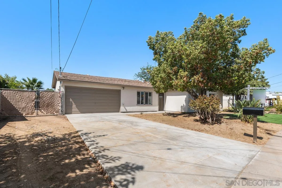 9257 Ruffin Road Santee, CA 92071 - Photo 26 of 28 a white house that has a tree in front of it