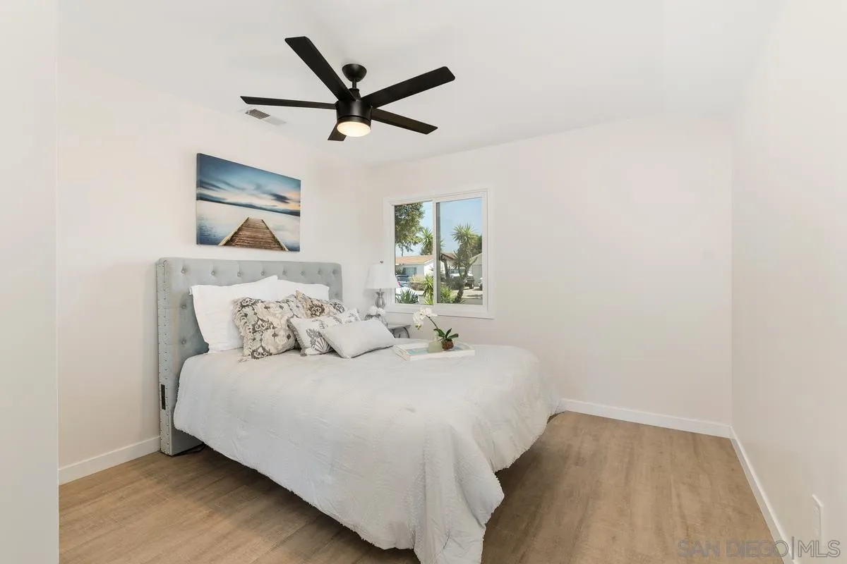 9257 Ruffin Road Santee, CA 92071 - Photo 8 of 28 a bedroom with a bed and painting on the wall
