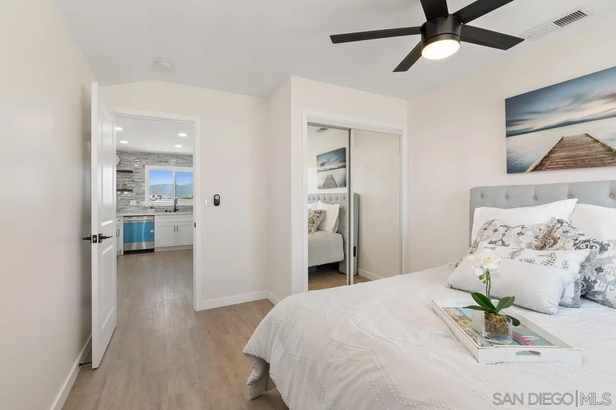 9257 Ruffin Road Santee, CA 92071 - Photo 9 of 28 a bedroom with a bed and a chandelier