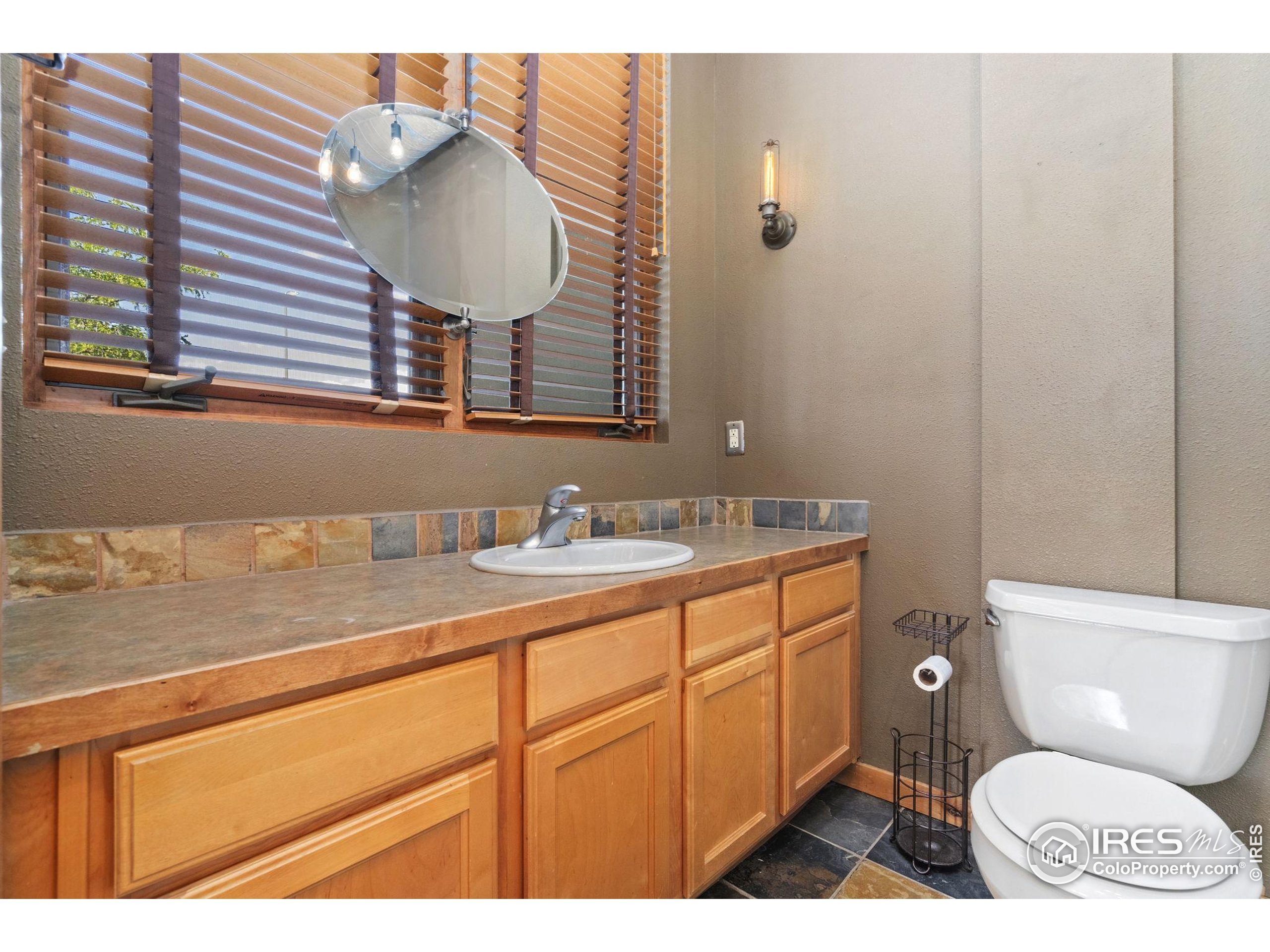 200 South College Avenue, Unit 201 Fort Collins, CO 80524 - Photo 14 of 19 a bathroom with a toilet a sink and mirror