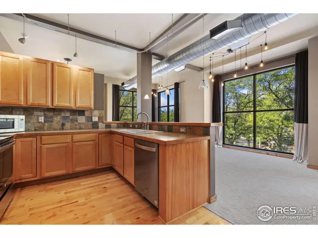 a kitchen with stainless steel appliances granite countertop a stove and a sink